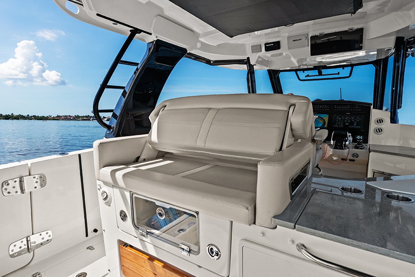 Helm deck second row seat with a conversation seatback