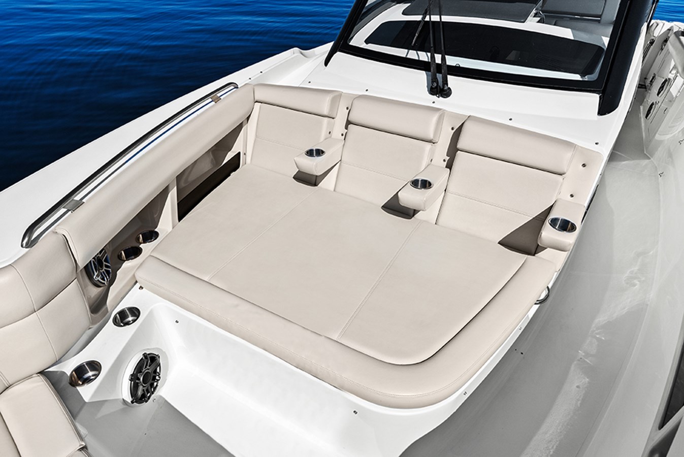 Bow lounge with backrest and fold-down armrests with integrated drink holders 