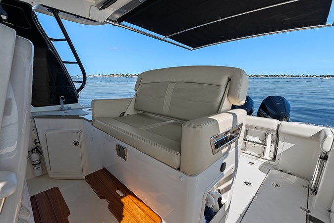Helm deck second row seat with a conversation seatback