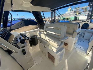 UNPLUGGED 1 2023 Boston Whaler 350 Realm interior with helm and seating area.