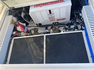 UNPLUGGED 8 Engine compartment of 2023 Boston Whaler 350 Realm with generator and fire extinguisher.