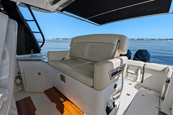 UNPLUGGED 17 Helm deck second row seat with a conversation seatback