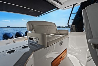 UNPLUGGED 18 Helm deck second row seat with a conversation seatback