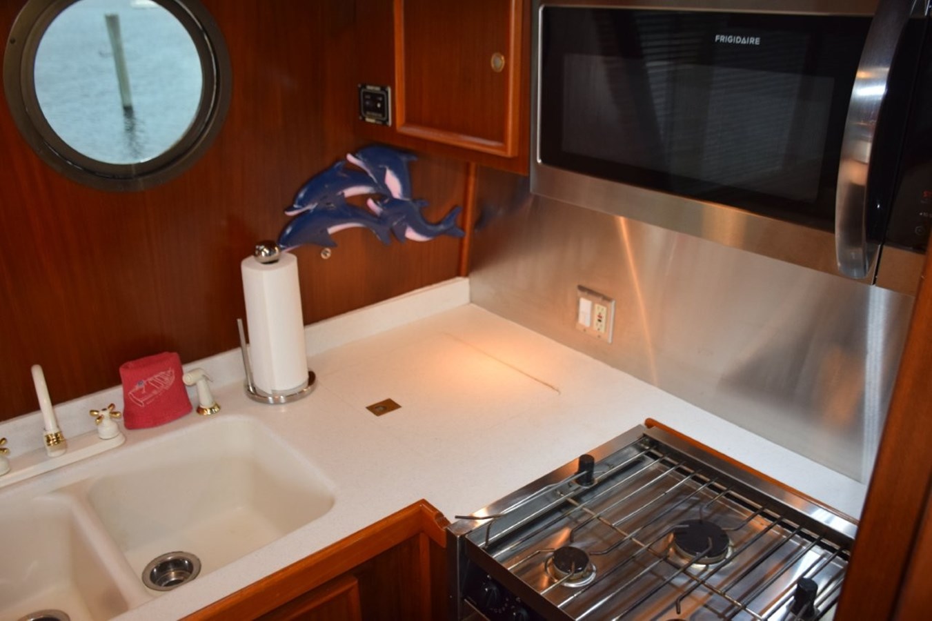 Custom galley with lolded countertop sink and stainless appliances and splash panels