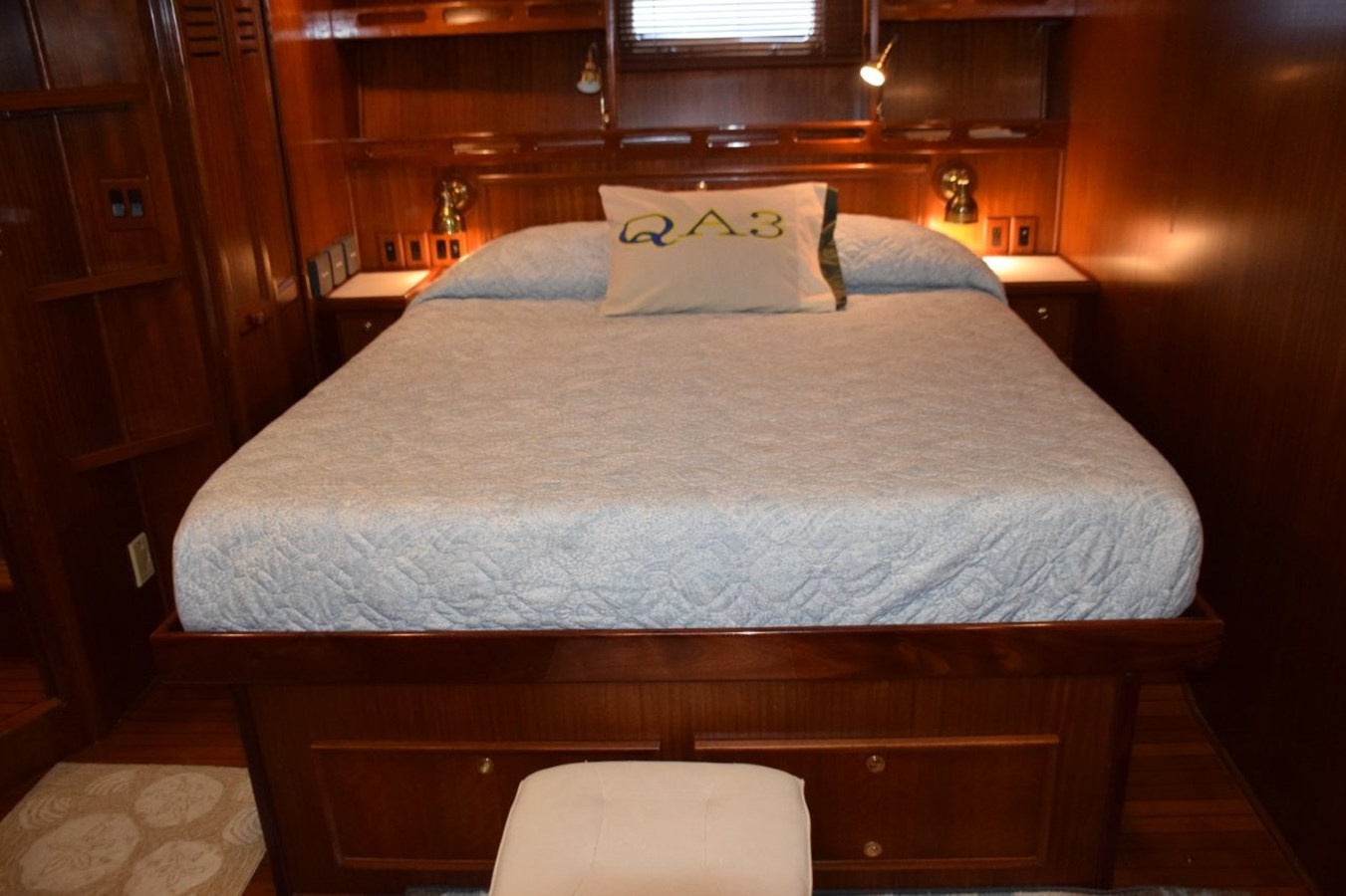 Comfortable berth with reading light and drawer storage beneath and in nightstand to either side of the bed