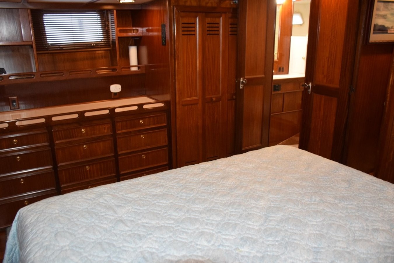  Portlights to either side of the stateroom and note abundance of drawers in dresser next to cedar lined hanging closet and head entry door
