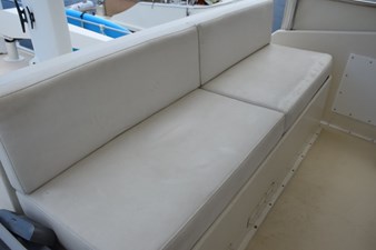 Helm deck aft companion bench seat with white vinyl cushions