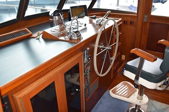Pilothouse has wing door and full helm chair
