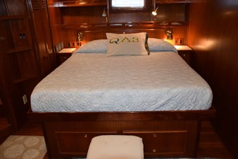 Comfortable berth with reading light and drawer storage beneath and in nightstand to either side of the bed