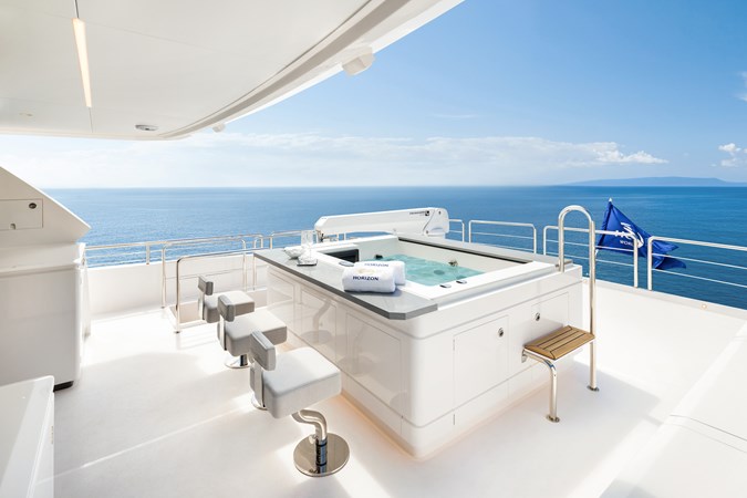 Horizon FD80 Hull 19 boat deck with hot tub and bar stools. 