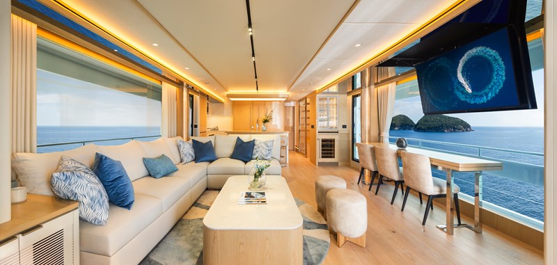 Horizon FD80 Hull 19 salon facing forward with TV and coffee table. 