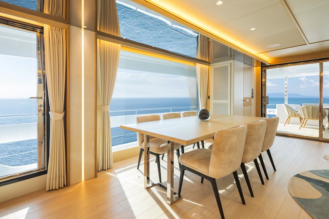 Horizon FD80 Hull 19 salon with dining table extended for 8 guests. 