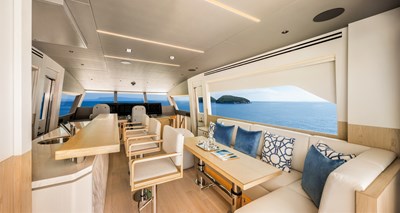 Horizon FD80 Hull 19 enclosed Skylounge with sofa and table.
