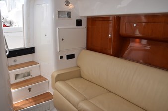 Cabin entry steps with wood treads, hanging locker to port, Fusion stereo base and Seakeeper displays