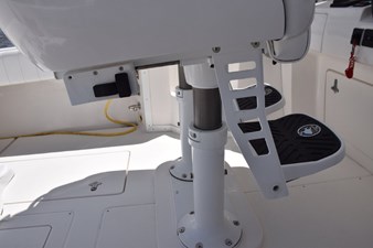 Electric helm seat adjustment and fold down foot rests